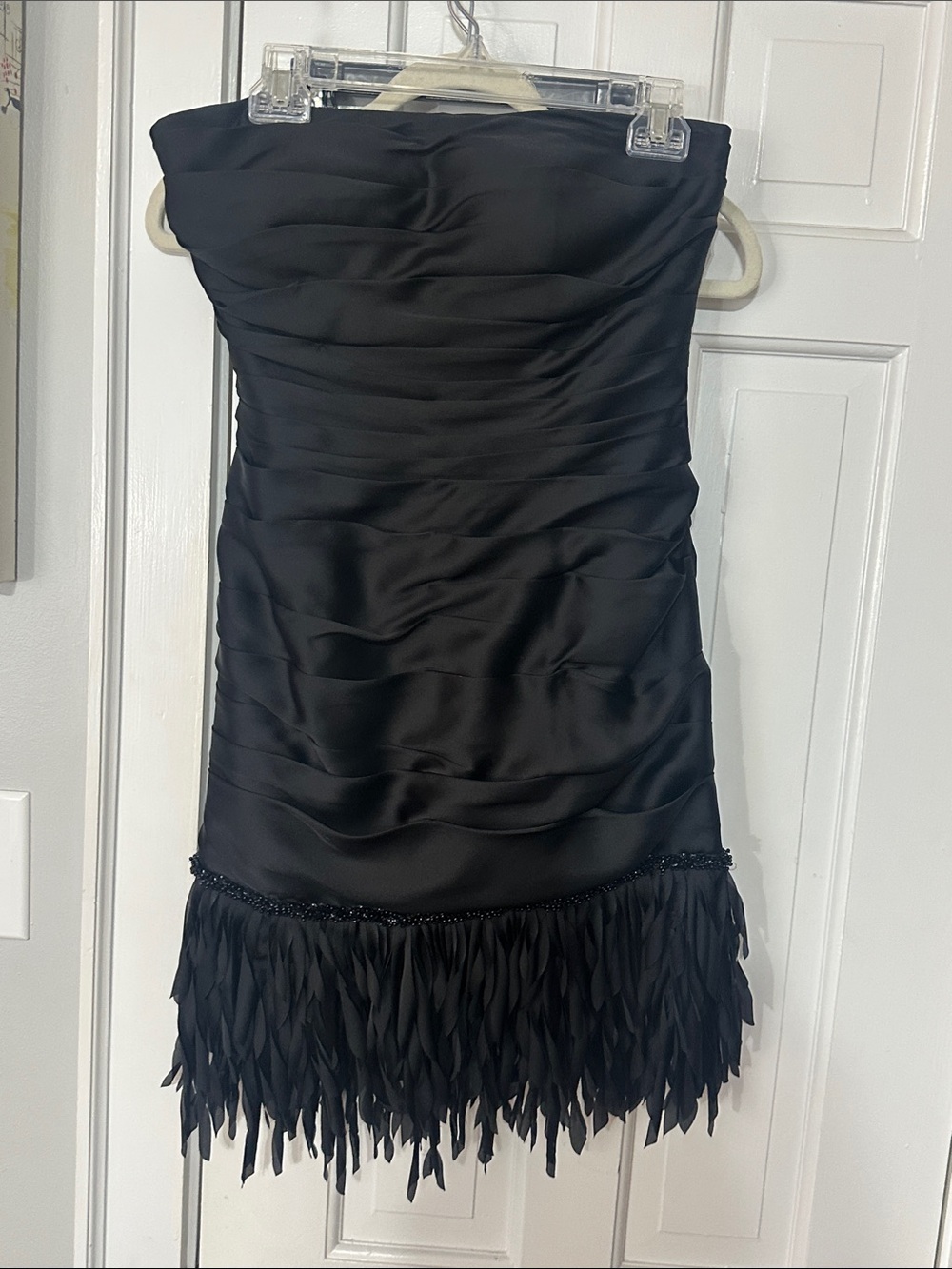 JS collection black cocktail dress strapless ruched body and beaded fringe hem.